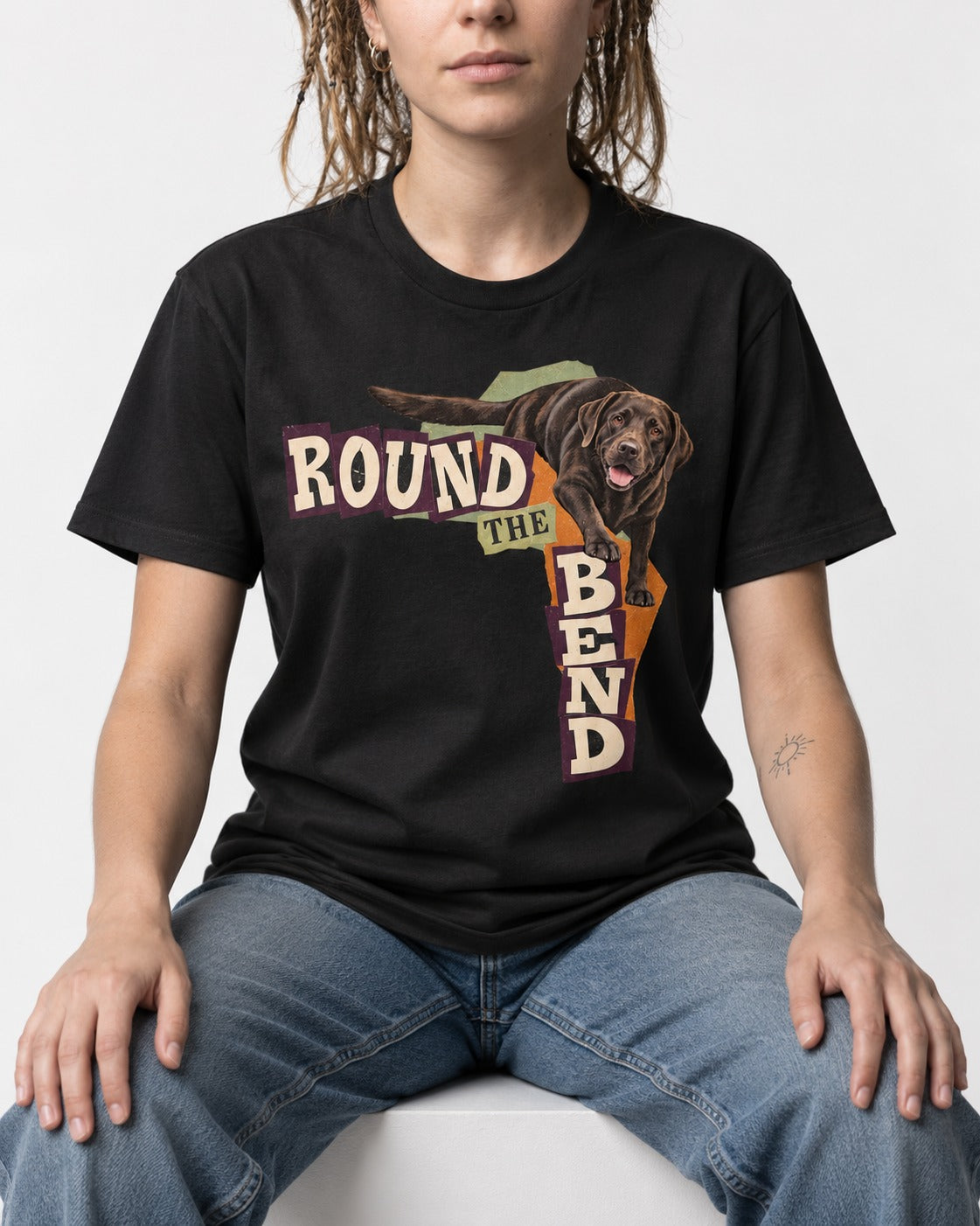 Labrador Retriever Round the Bend Collage Graphic T-Shirt in Black, worn by a seated model