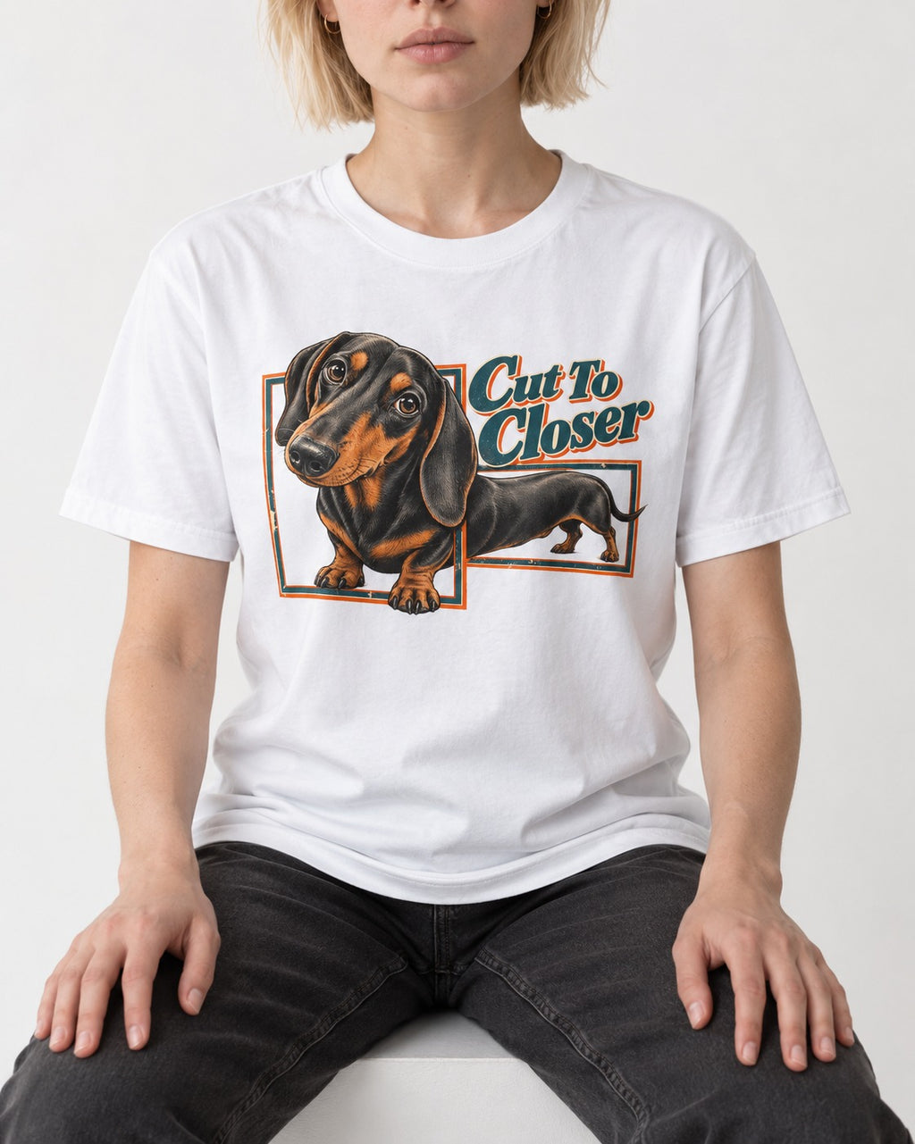 Dachshund Cut to Closer T-Shirt in White, worn by a seated model