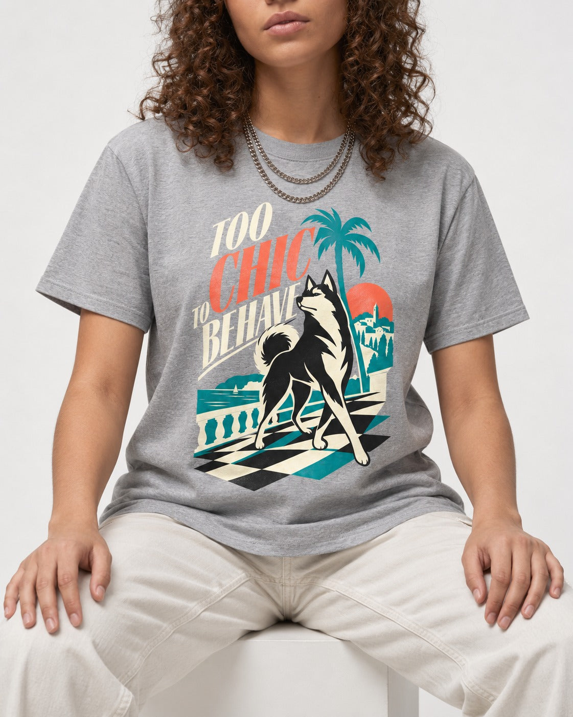 Husky Too Chic to Behave Riviera Graphic T-Shirt in Sport Grey, worn by a seated model