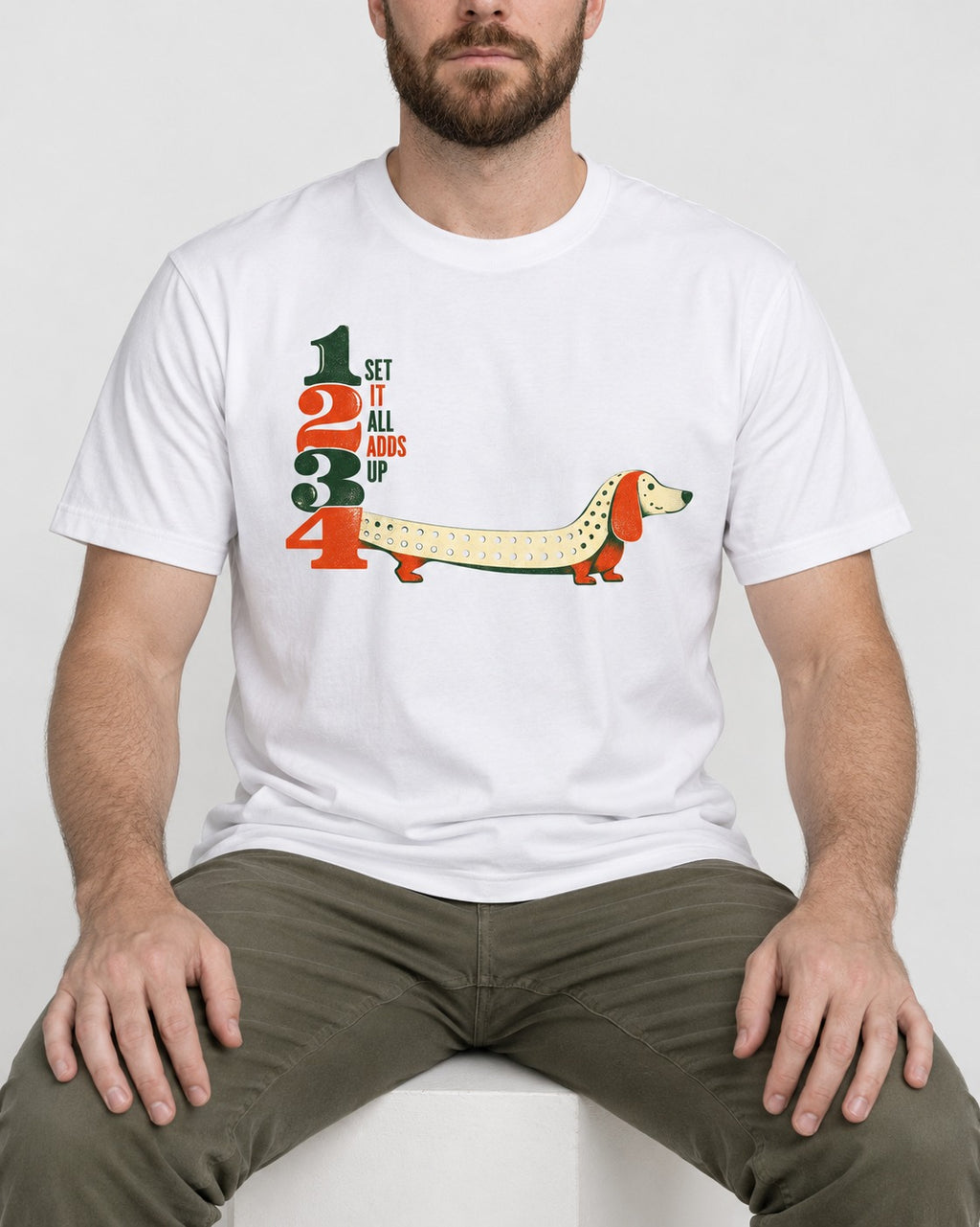 Dachshund Adds Up T-Shirt in White, worn by a seated model