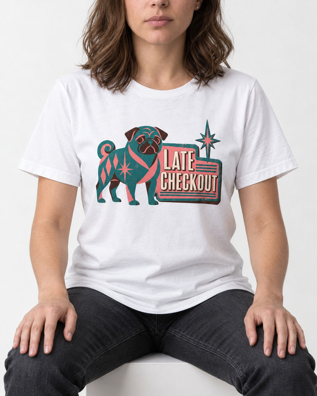 Pug's Late Checkout T-Shirt in White, worn by a seated model