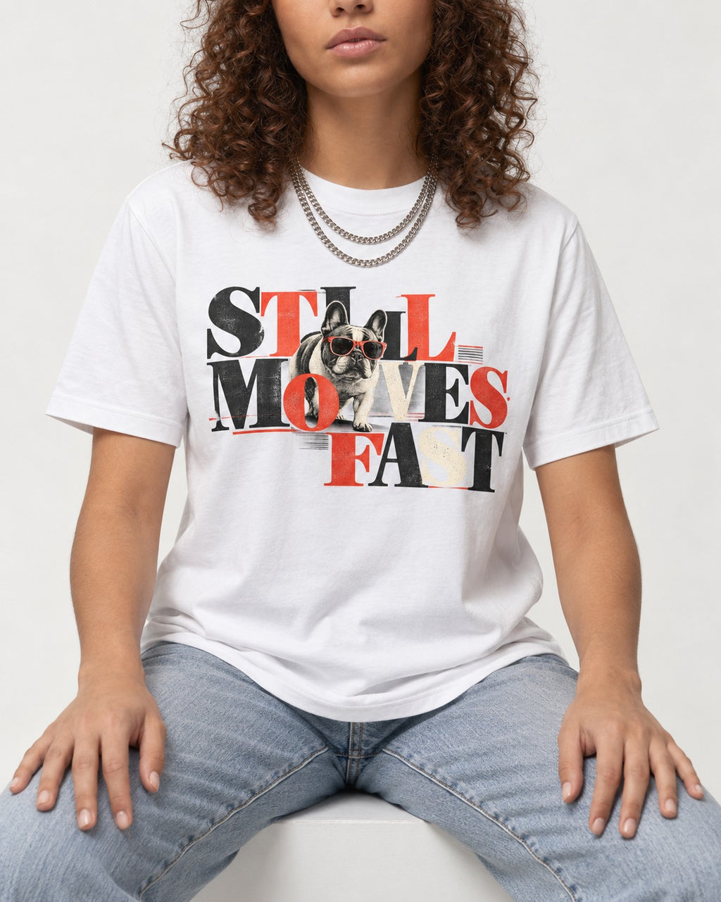 Frenchie Still Moves Fast T-Shirt in White, worn by a seated model