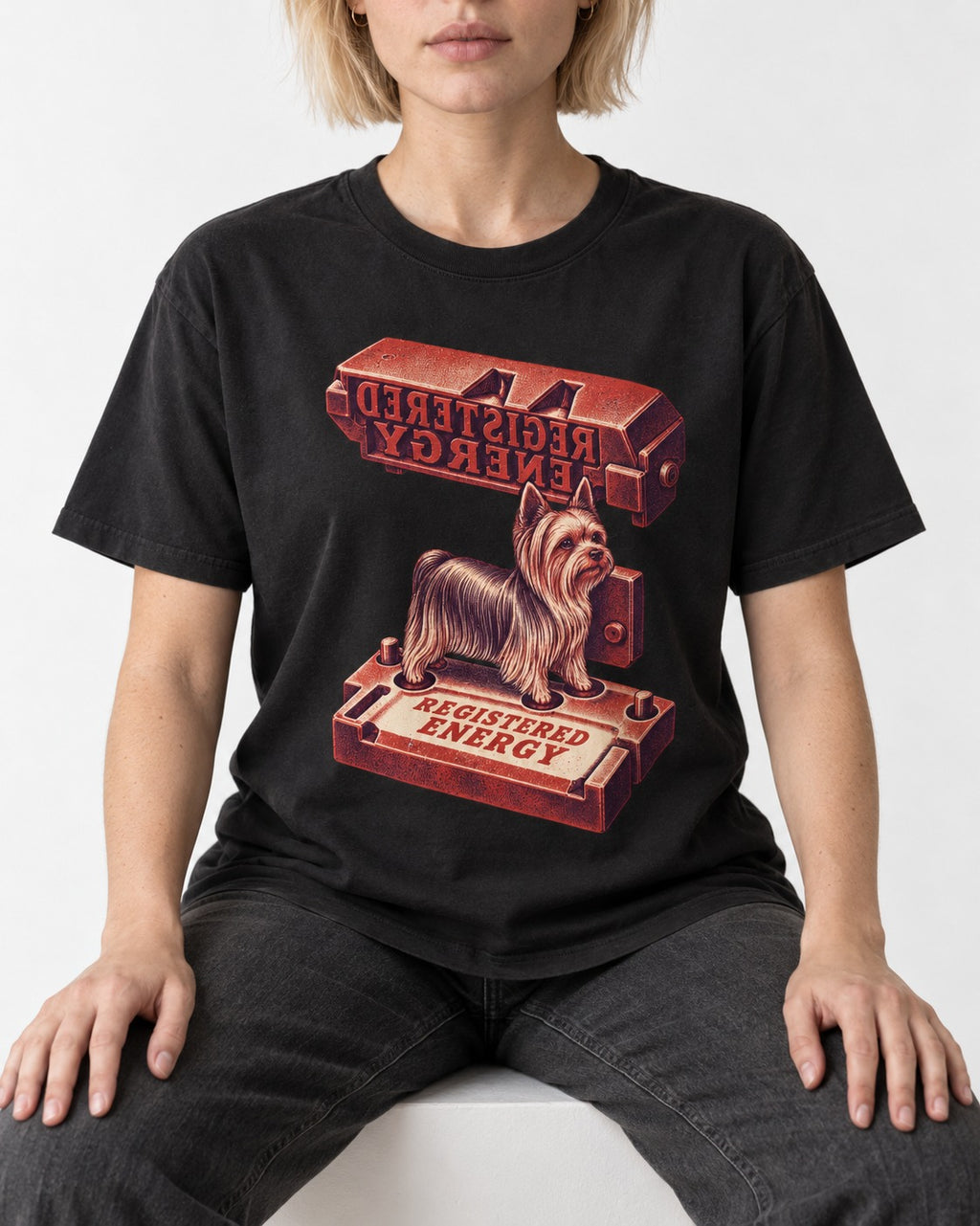 Yorkshire Terrier Registered Energy Stamp Press Graphic T-Shirt in Black, worn by a seated model
