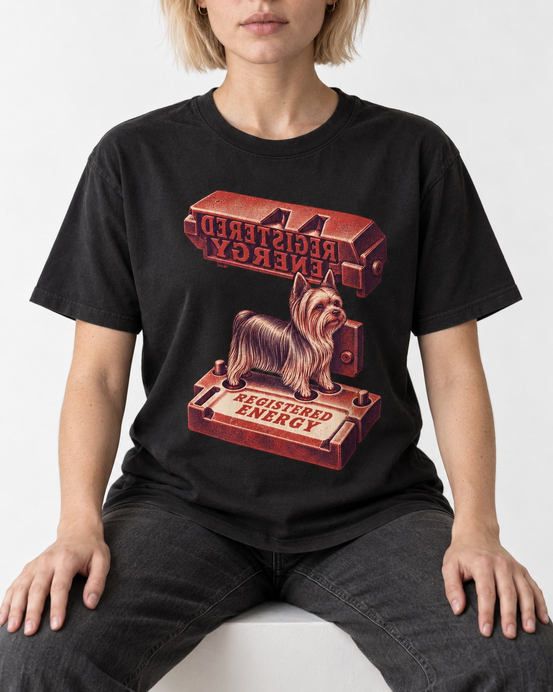 Yorkshire Terrier Registered Energy Stamp Press Graphic T-Shirt in Black, worn by a seated model