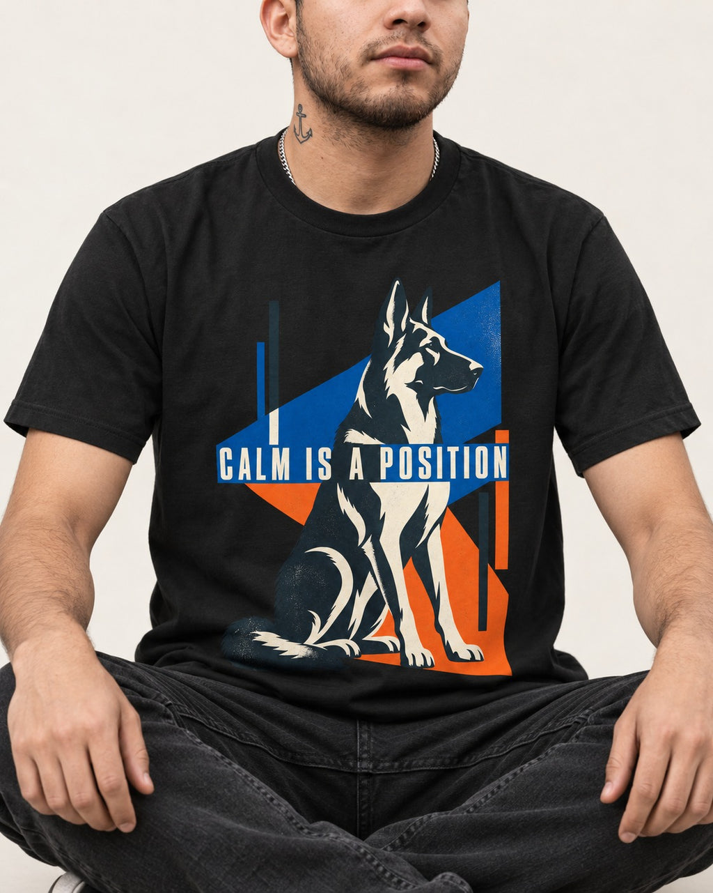Calm Is A Position Geometric German Shepherd Dog Graphic T-Shirt in Black, worn by a seated model