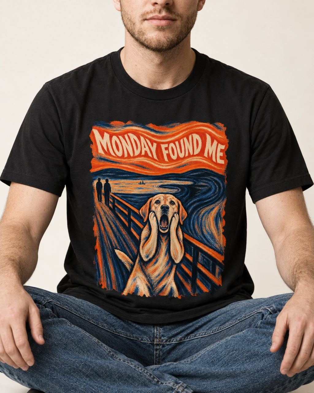 Labrador Retriever Monday Found Me Scream Parody Graphic T-Shirt in Black, worn by a seated model