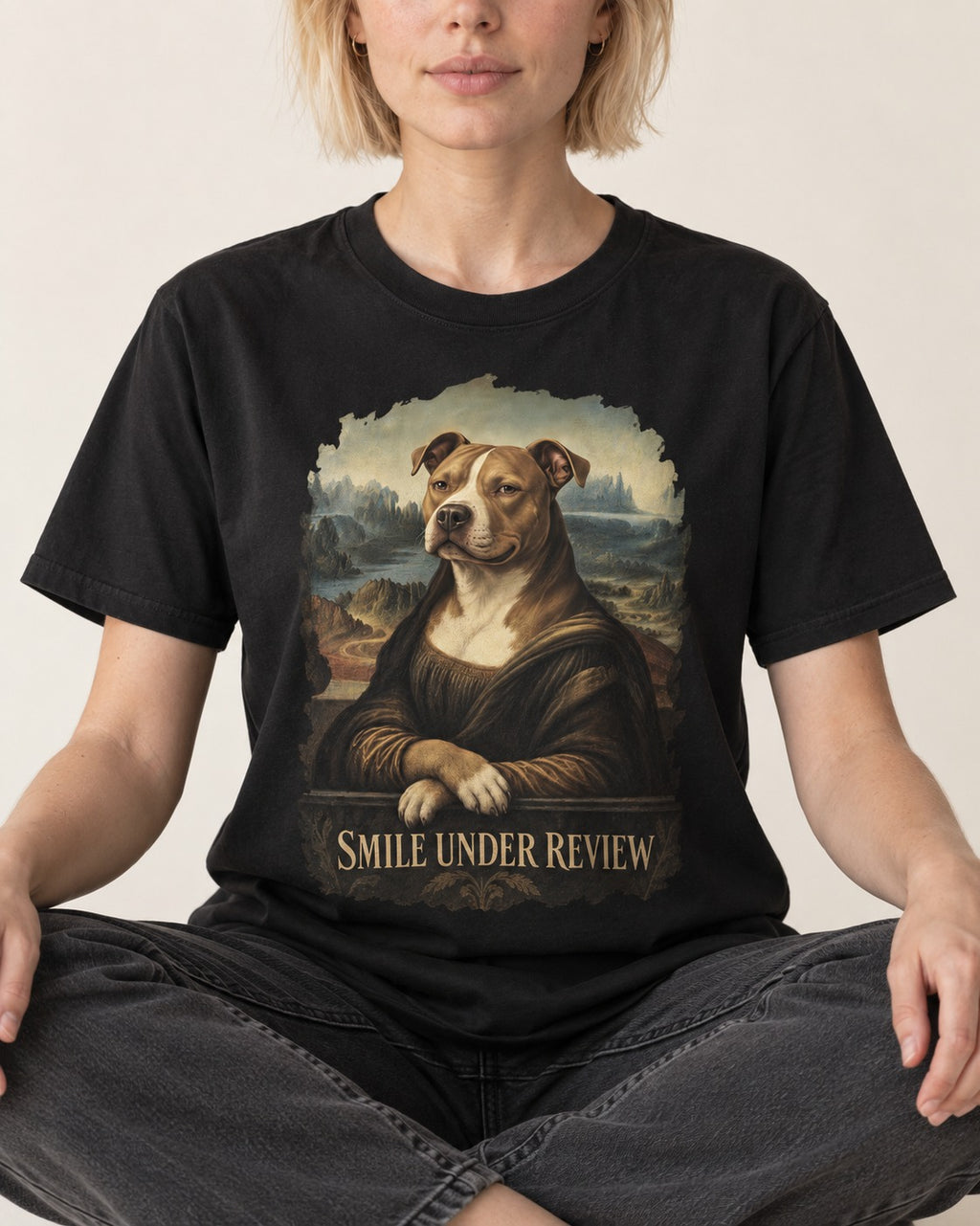Pitbull Smile Under Review Renaissance Portrait Graphic T-Shirt in Black, worn by a seated model