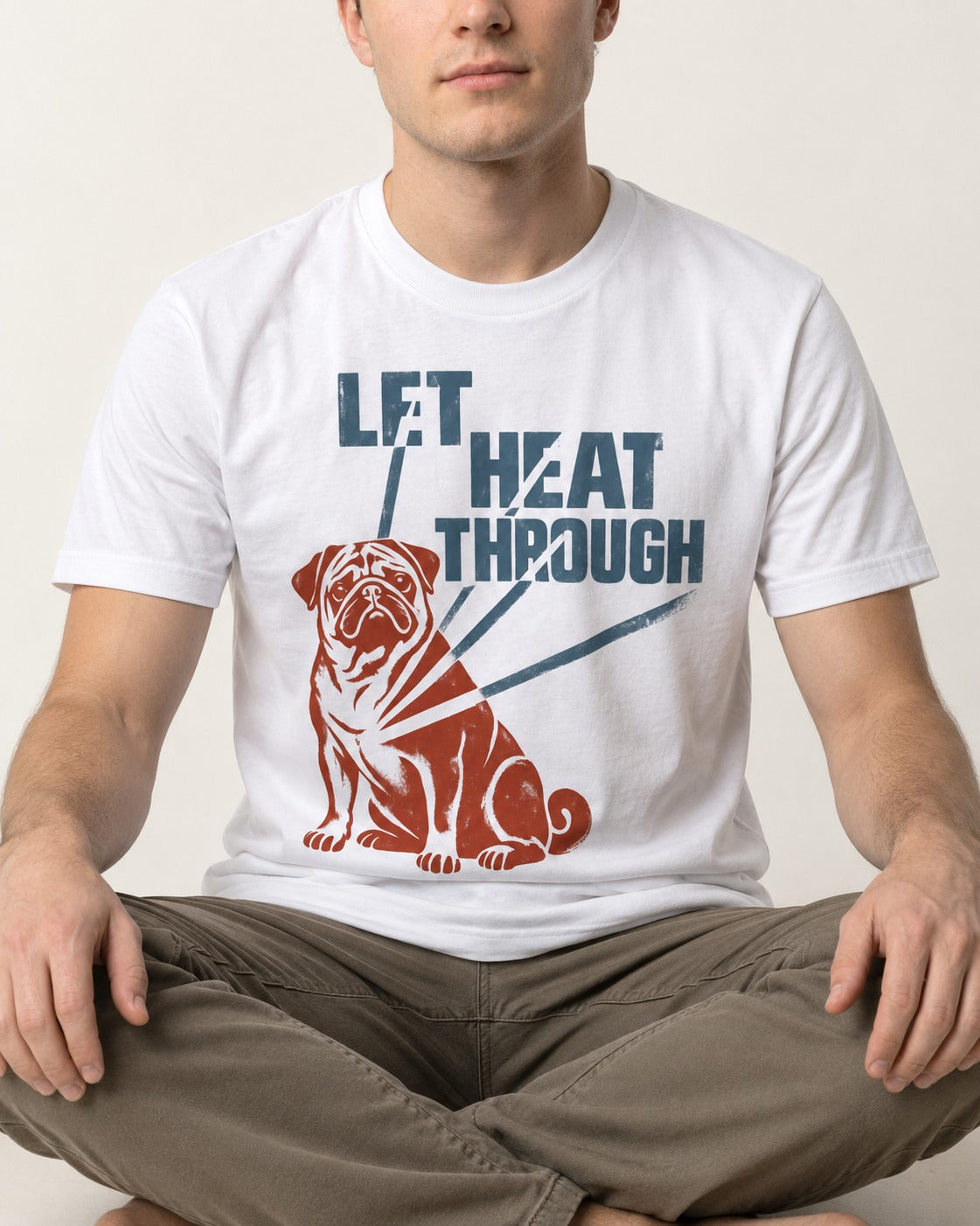 Let the Pug Through T-Shirt in White, worn by a seated model