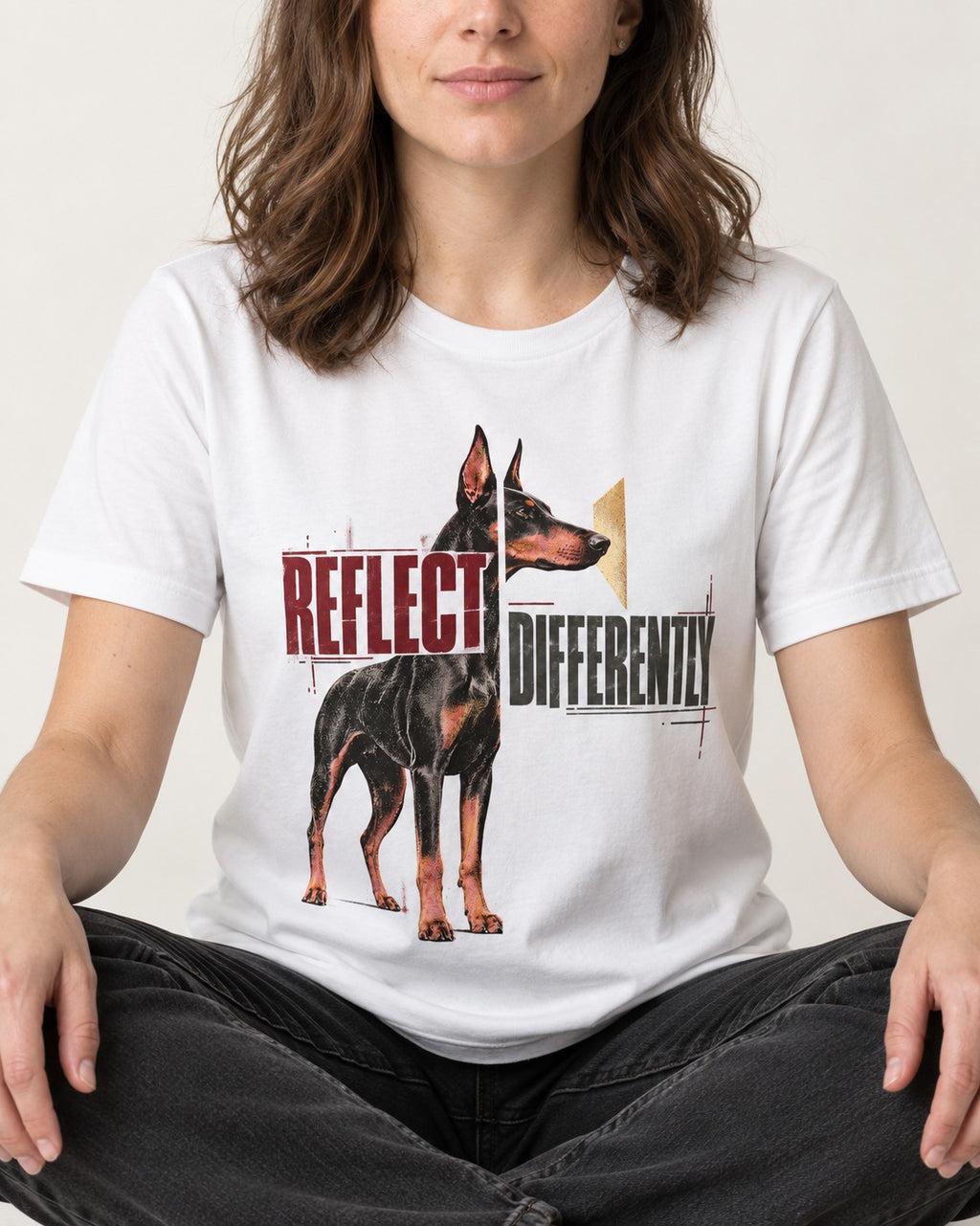 Doberman Reflects Differently T-Shirt in White, worn by a seated model