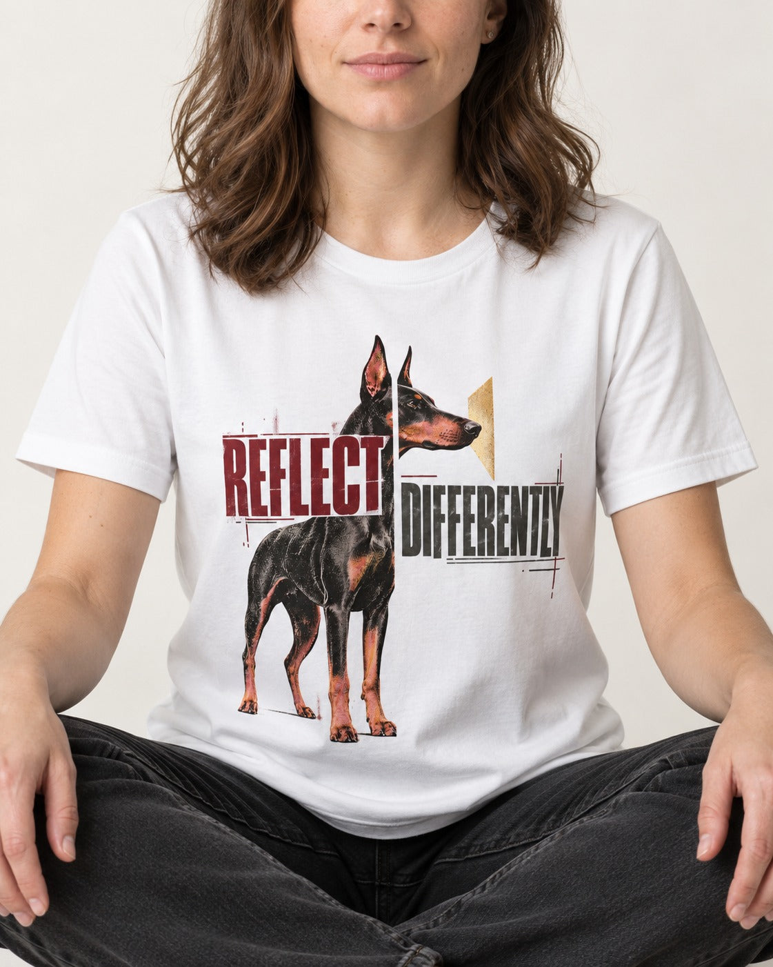 Doberman Reflects Differently T-Shirt in White, worn by a seated model