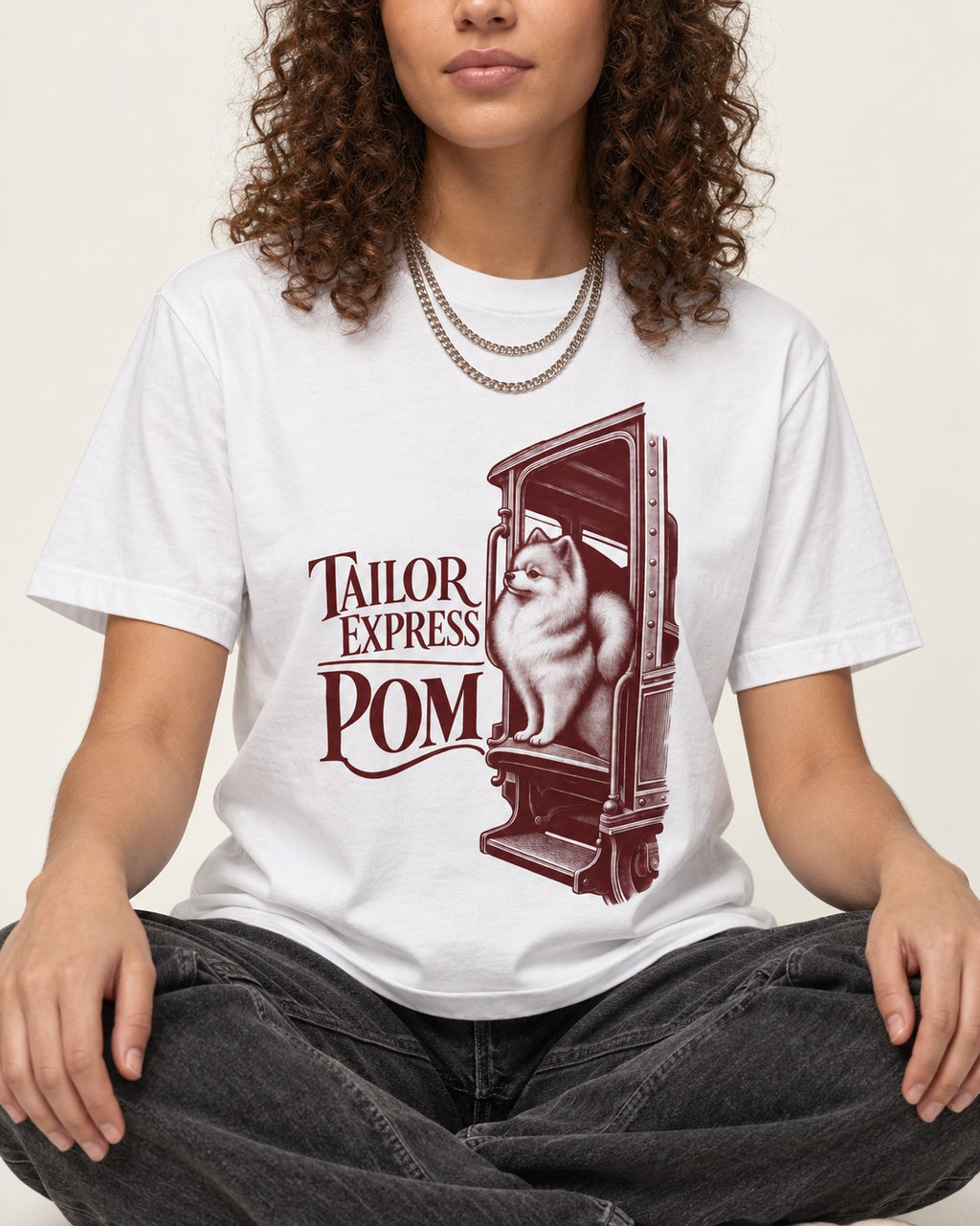 Pomeranian Express T-Shirt in White, worn by a seated model