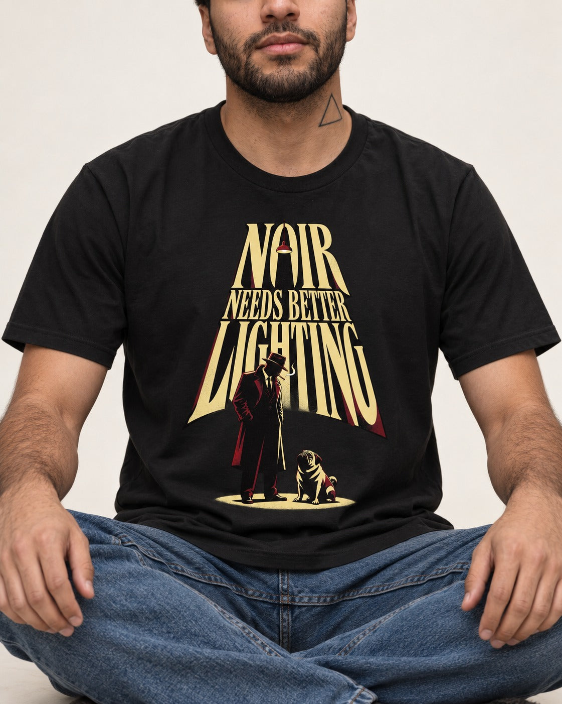 Pug Noir Needs Better Lighting Detective Graphic T-Shirt in Black, worn by a seated model