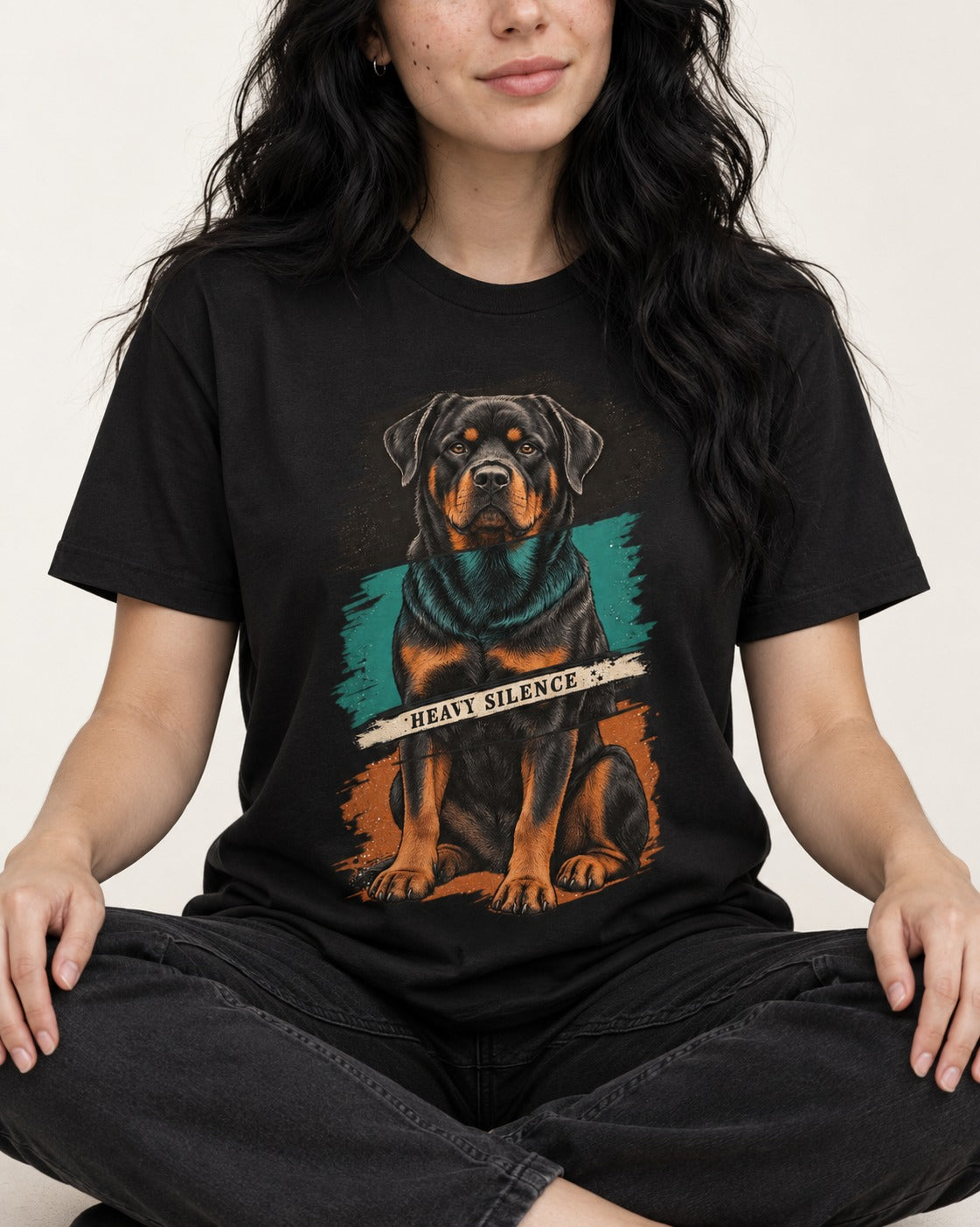Rottweiler Heavy Silence Brushstroke Portrait Graphic T-Shirt in Black, worn by a seated model