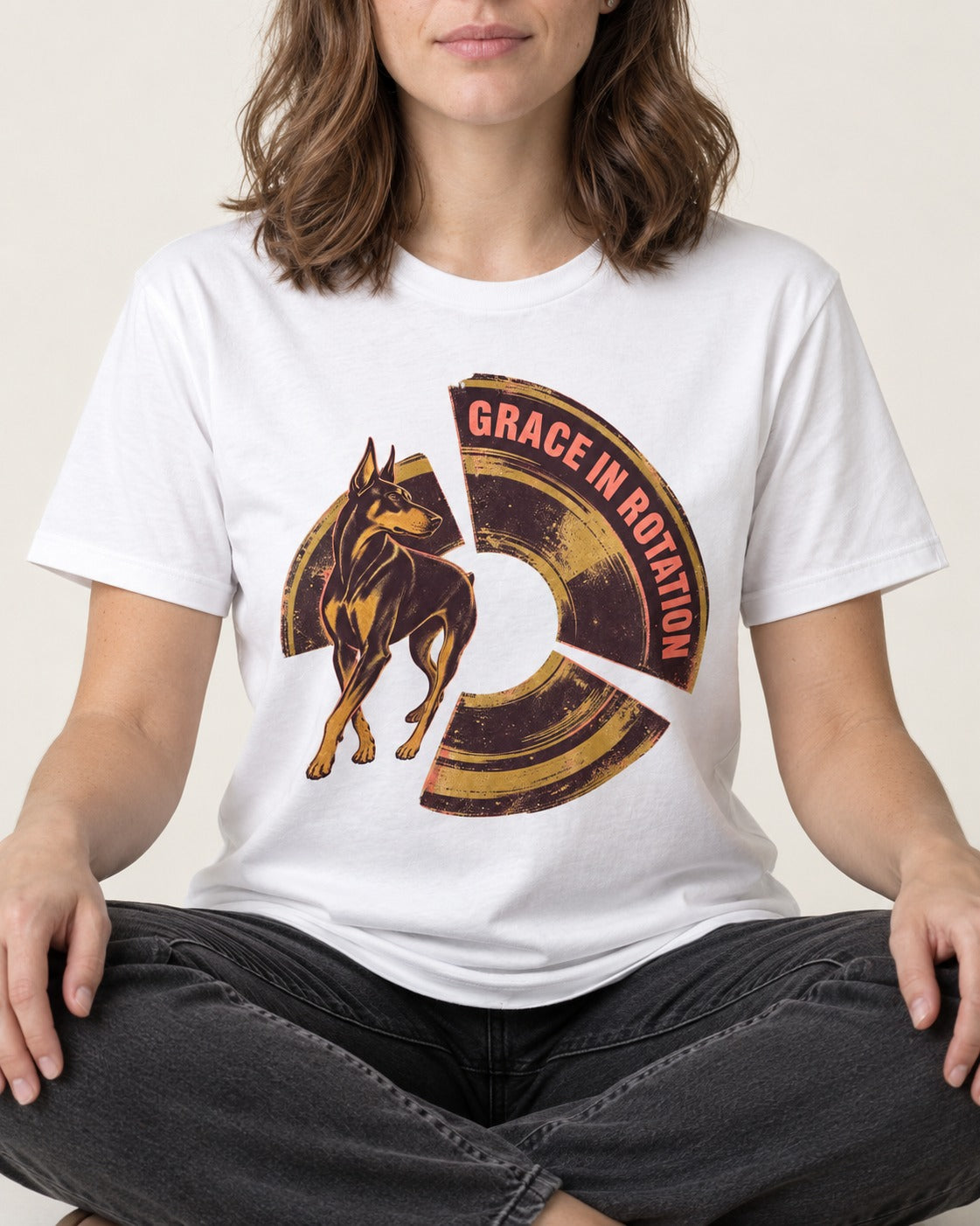Doberman Grace in Rotation T-Shirt in White, worn by a seated model