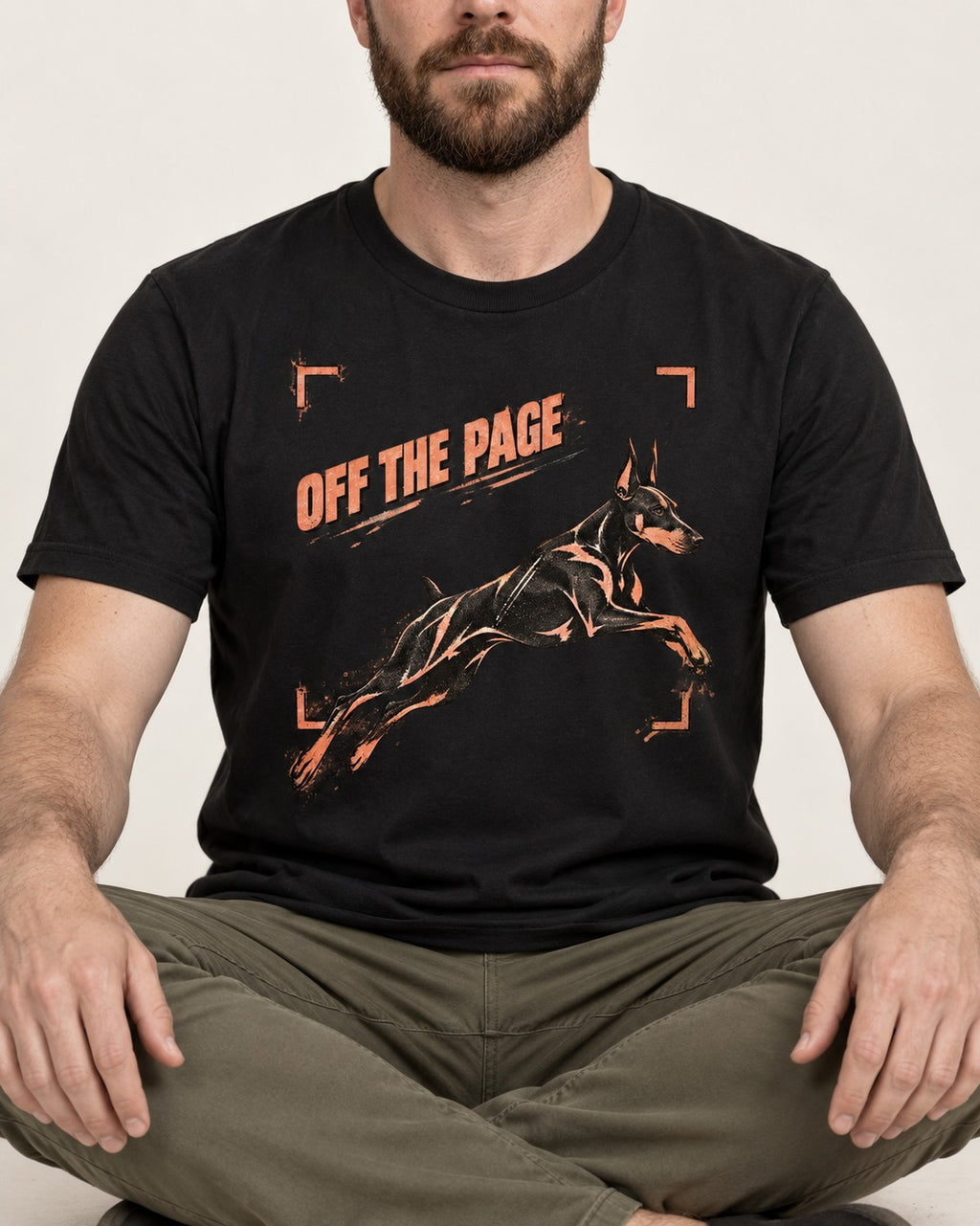 Doberman Off the Page Focus Frame Graphic T-Shirt in Black, worn by a seated model