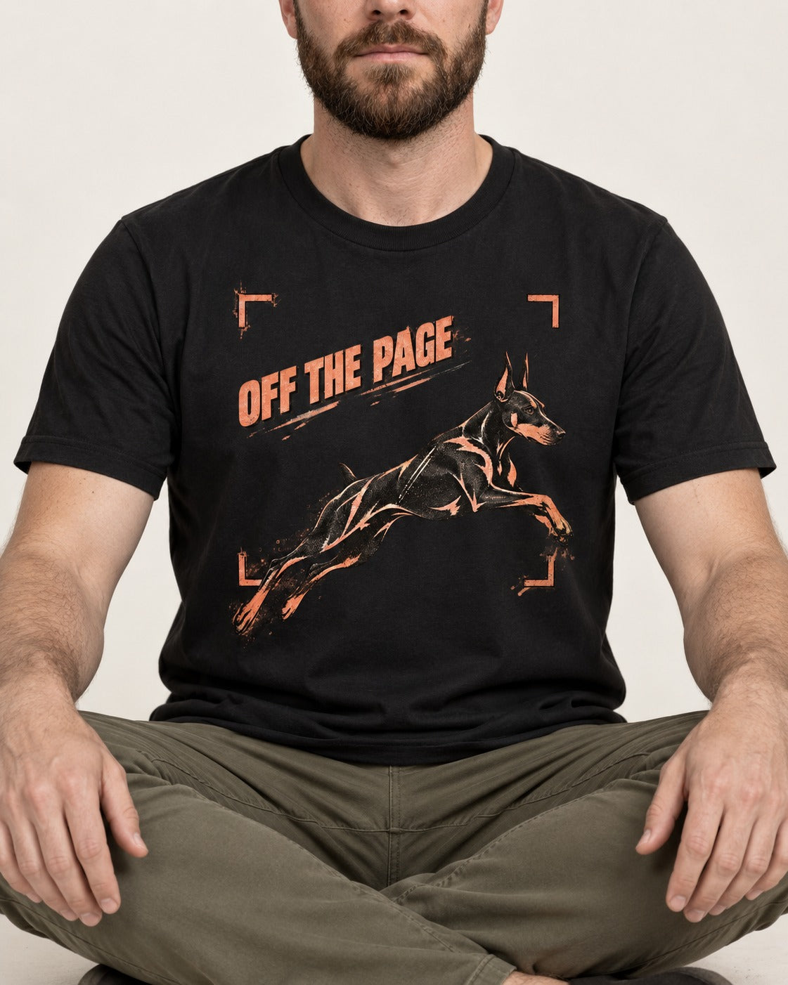 Doberman Off the Page Focus Frame Graphic T-Shirt in Black, worn by a seated model