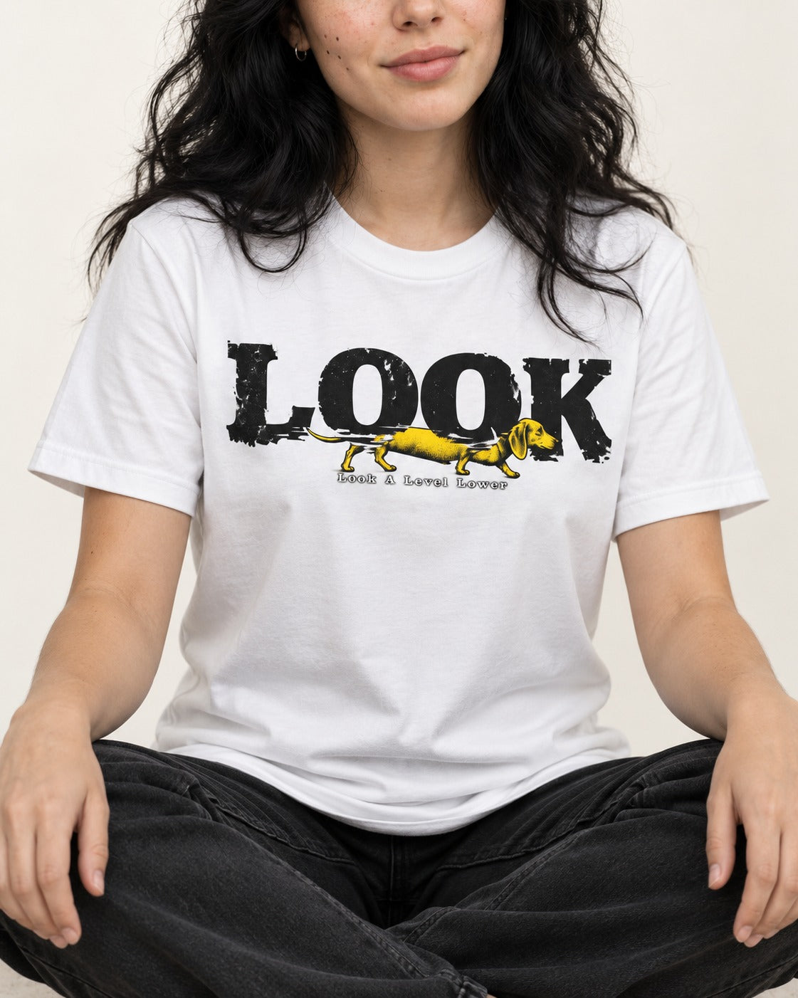 Look Lower for Dachshund T-Shirt in White, worn by a seated model