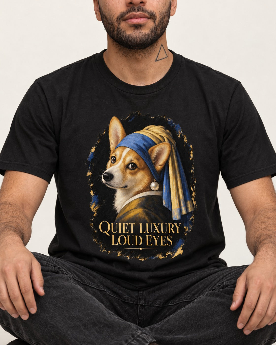 Corgi Quiet Luxury Loud Eyes Pearl Earring Portrait T-Shirt in Black, worn by a seated model