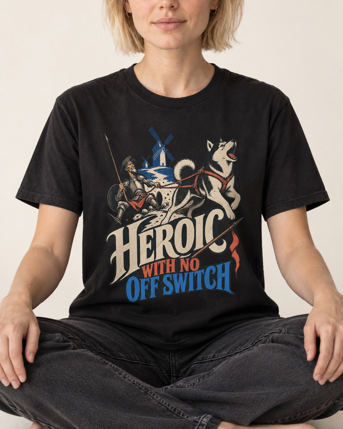 Husky Heroic with No Off Switch Don Quixote Graphic T-Shirt in Black, worn by a seated model
