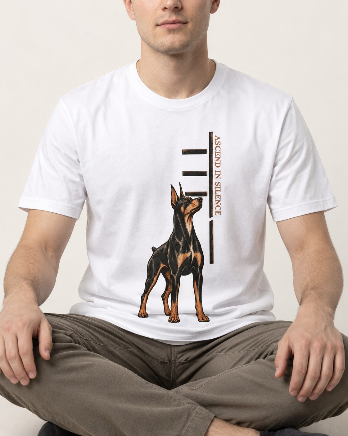 Doberman Ascend in Silence T-Shirt in White, worn by a seated model