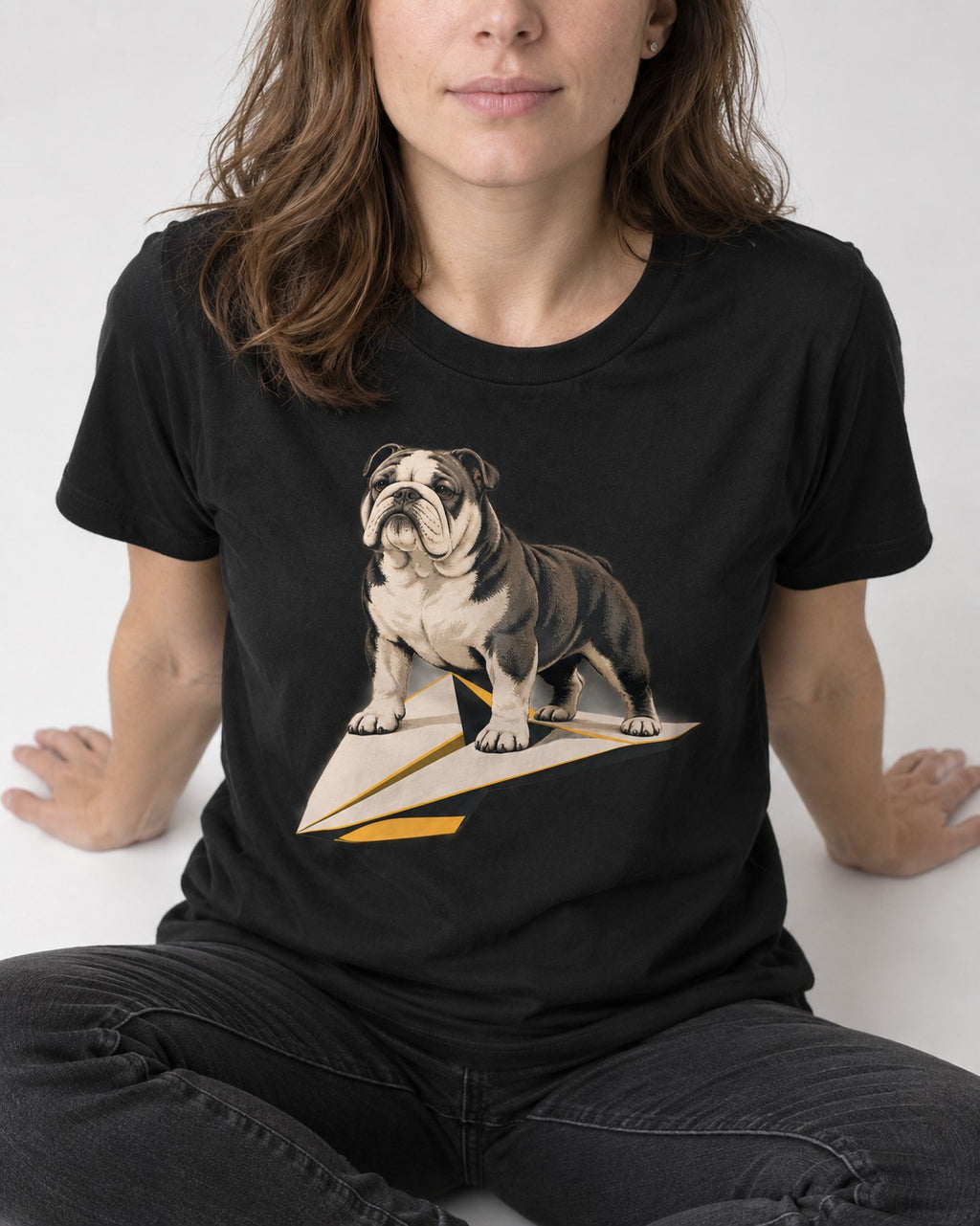English Bulldog Paper Airplane Graphic T-Shirt in Black, worn by a seated model