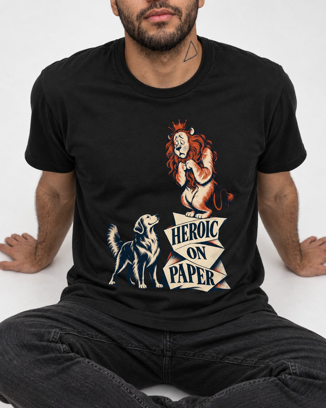 Golden Retriever Heroic on Paper Lion Graphic T-Shirt in Black, worn by a seated model