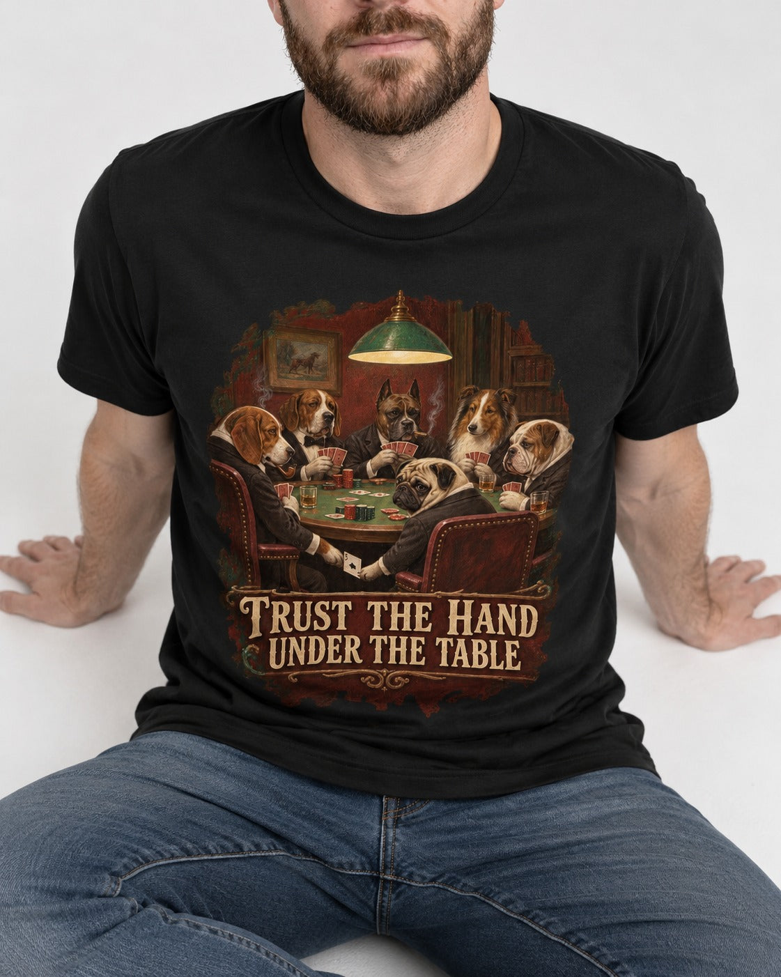 Pug Trust the Hand Under the Table Poker Graphic T-Shirt in Black, worn by a seated model