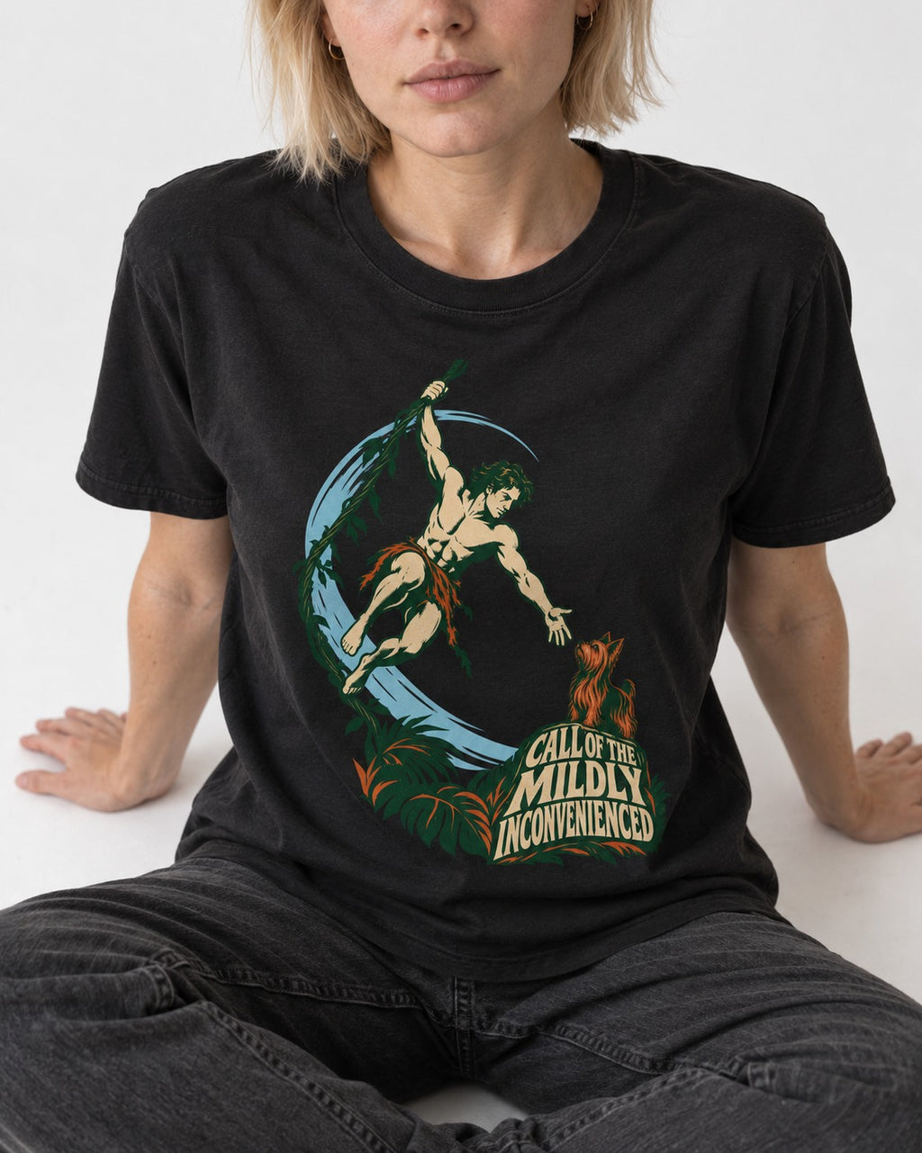 Yorkshire Terrier Call of the Mildly Inconvenienced Vine Swing Graphic T-Shirt in Black, worn by a seated model