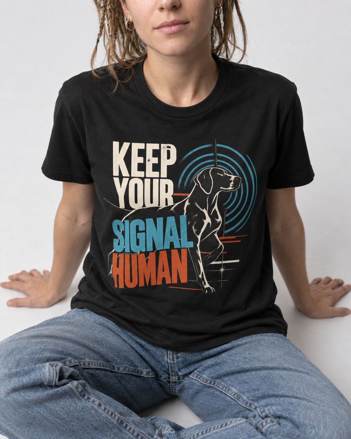 German Shorthaired Pointer Keep Your Signal Human Broadcast Graphic T-Shirt in Black, worn by a seated model
