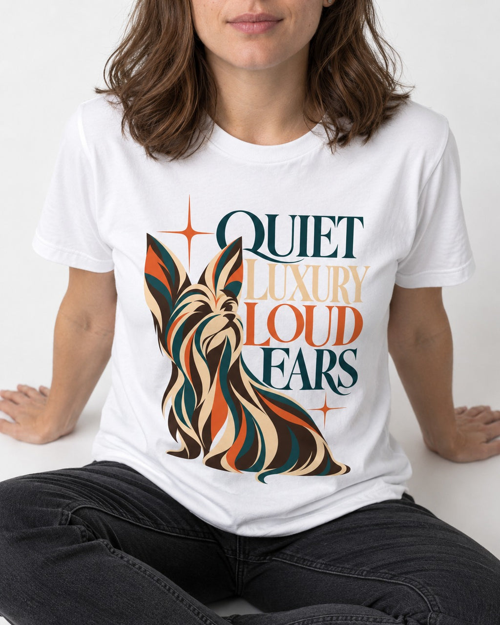Quiet Luxury Loud Ears Yorkshire Terrier T-Shirt in White, worn by a seated model