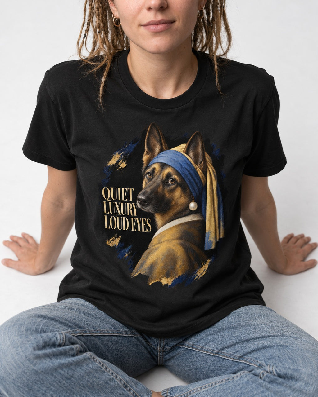 German Shepherd Dog Quiet Luxury Loud Eyes Pearl Portrait T-Shirt in Black, worn by a seated model