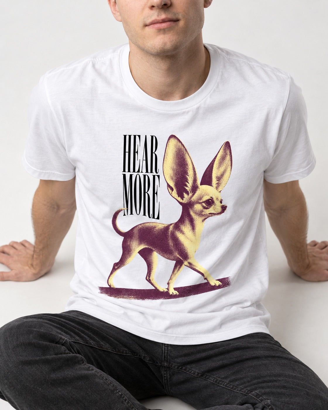 Hear More Chihuahua T-Shirt in White, worn by a seated model