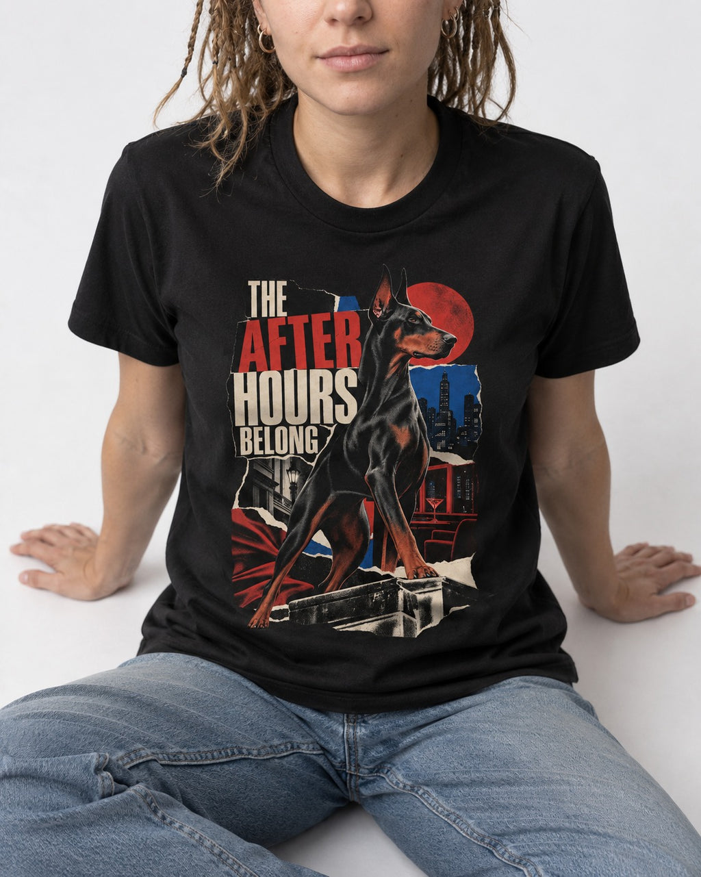 Doberman The After Hours Belong City Collage T-Shirt in Black, worn by a seated model