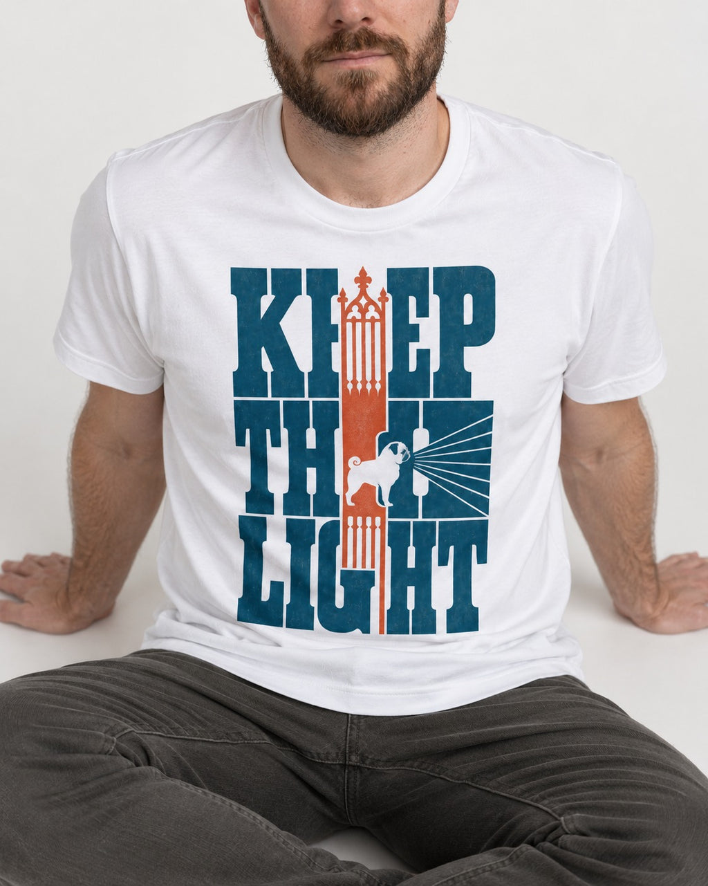 Keep the Pug Fight T-Shirt in White, worn by a seated model