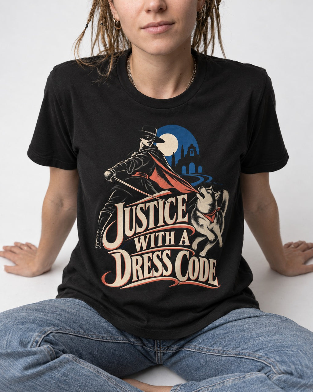 Husky Justice With A Dress Code Masked Swordsman Graphic T-Shirt in Black, worn by a seated model