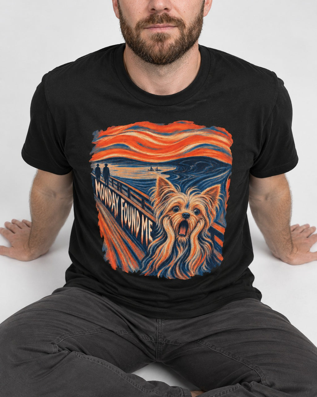 Yorkshire Terrier Monday Found Me Scream Parody Graphic T-Shirt in Black, worn by a seated model