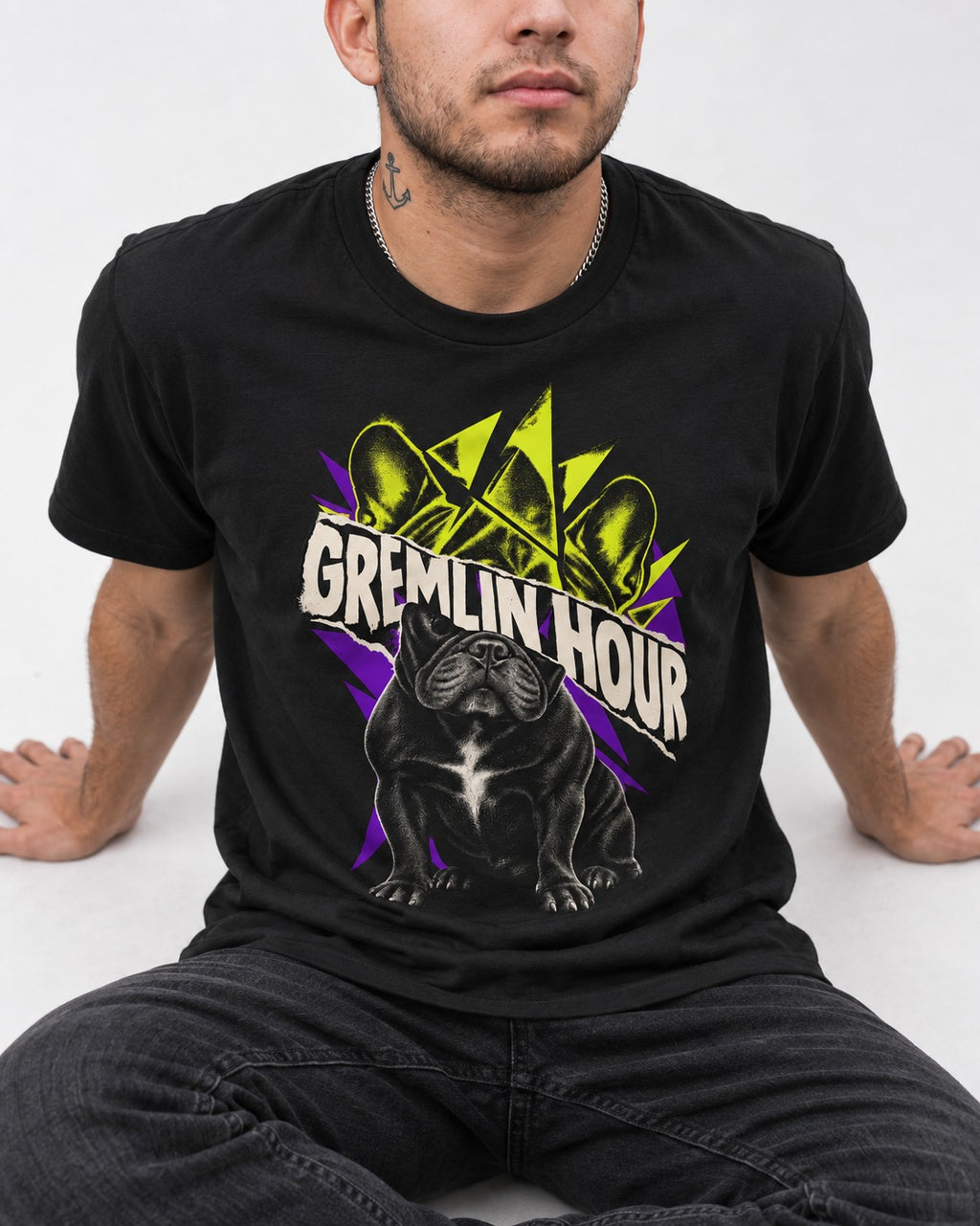 Frenchie Gremlin Hour Fracture Portrait Graphic T-Shirt in Black, worn by a seated model