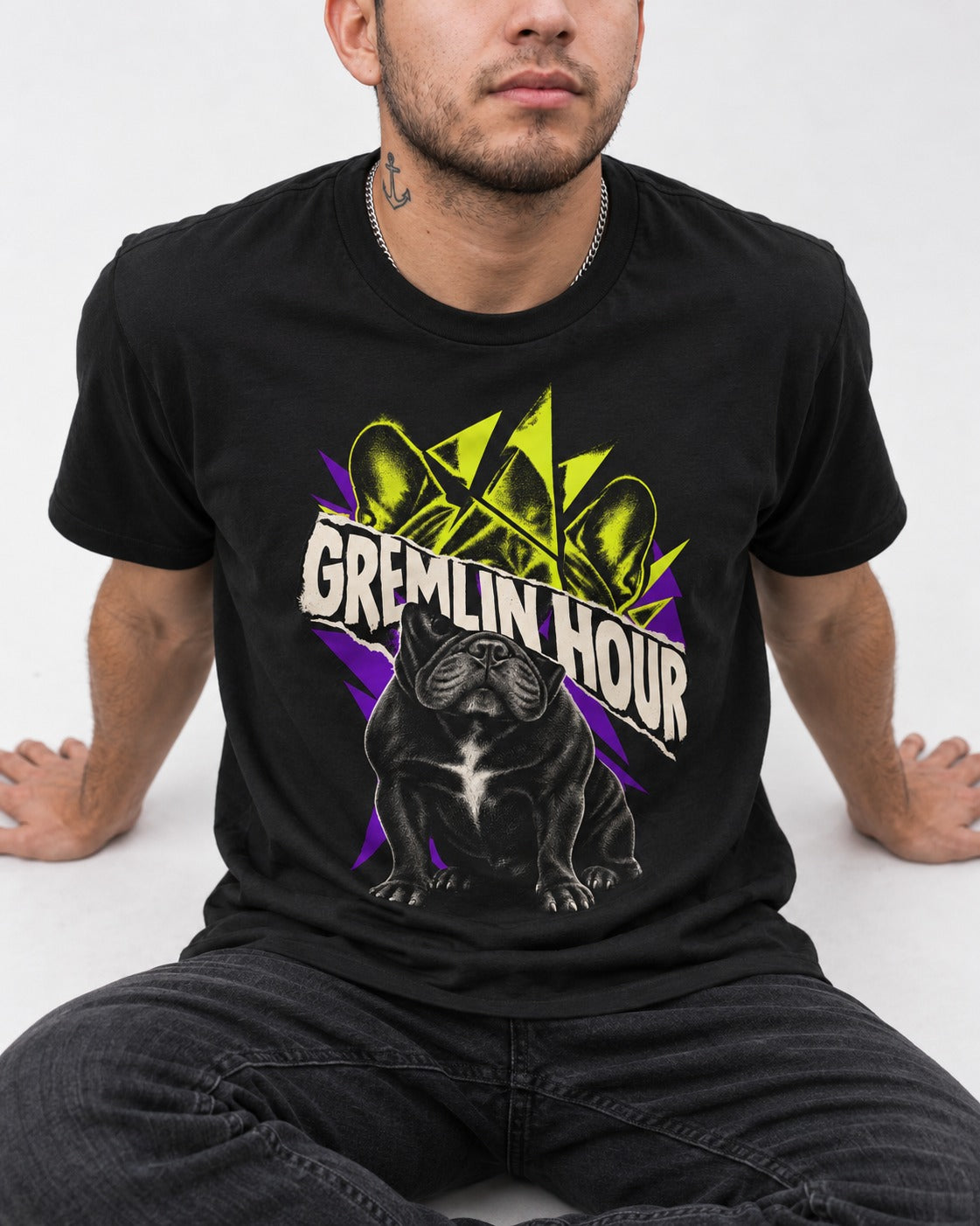 Frenchie Gremlin Hour Fracture Portrait Graphic T-Shirt in Black, worn by a seated model