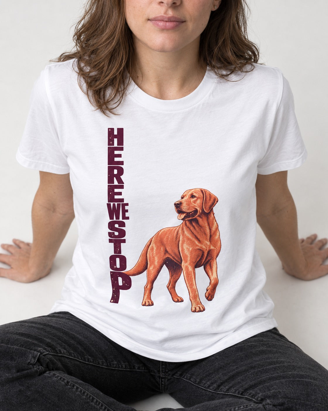Here We Stop Labrador Retriever T-Shirt in White, worn by a seated model