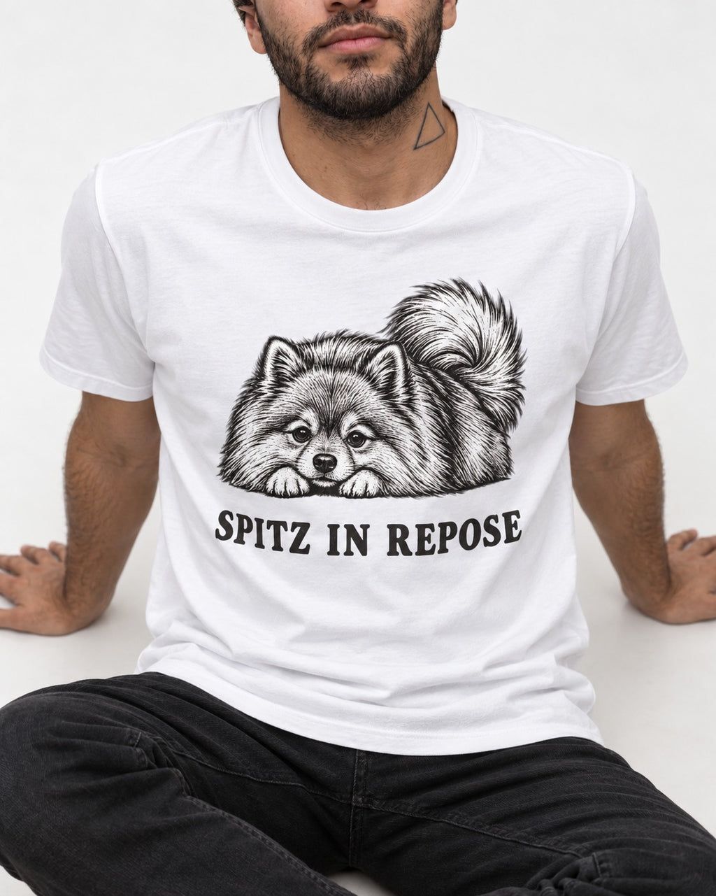 Pomeranian In Repose T-Shirt in White, worn by a seated model