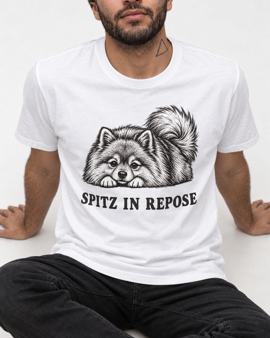 Pomeranian In Repose T-Shirt in White, worn by a seated model