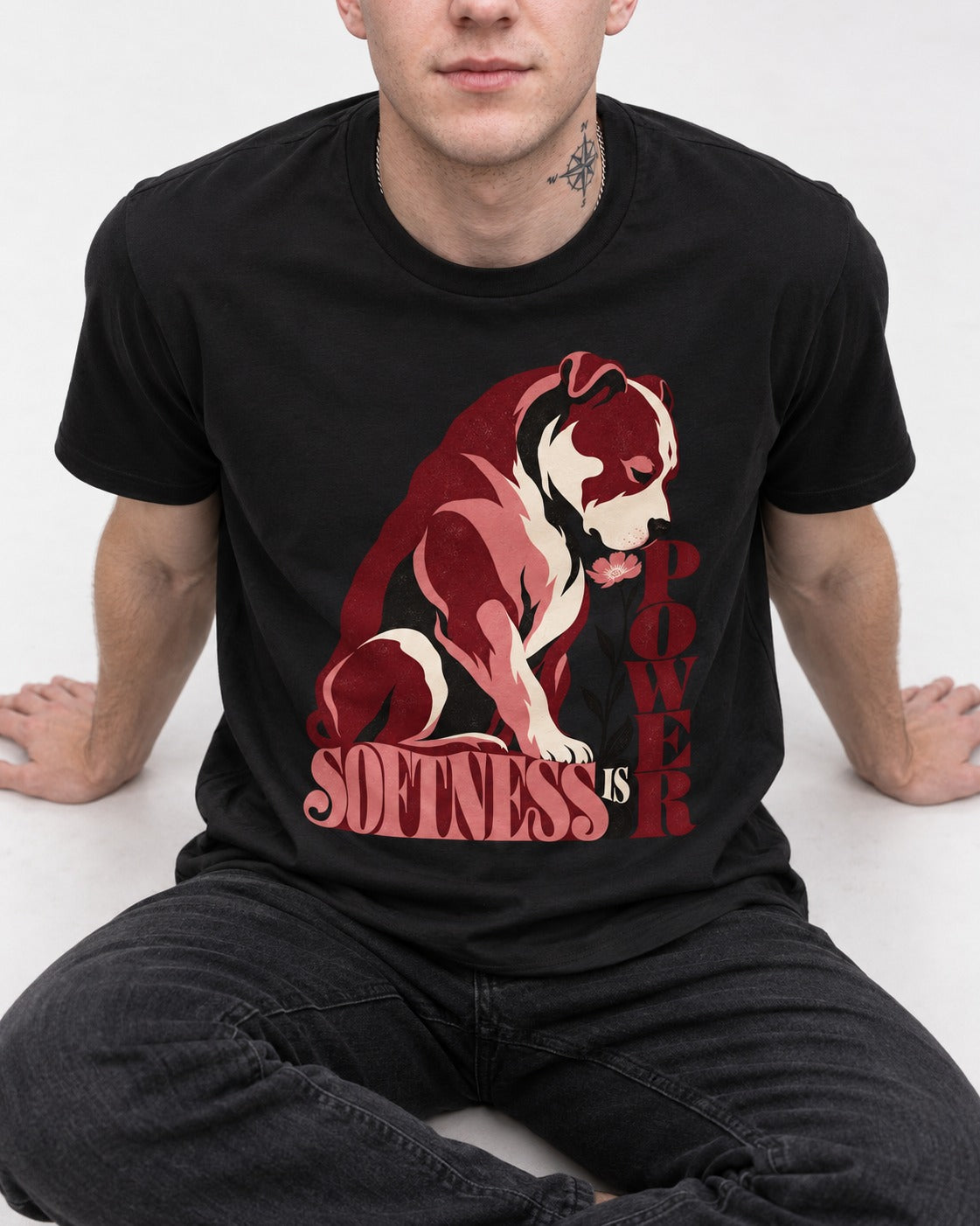 Pitbull Softness Is Power Flower Graphic T-Shirt in Black, worn by a seated model