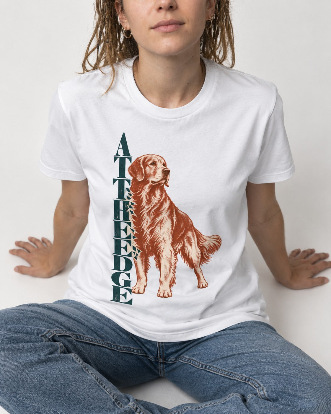 Golden Retriever At the Edge T-Shirt in White, worn by a seated model