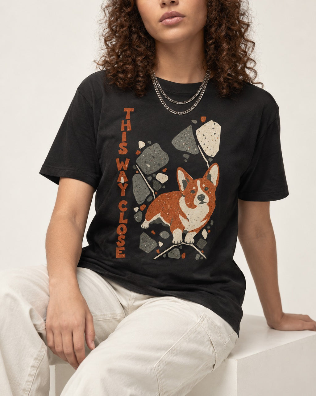 Corgi This Way Close Rubble Graphic T-Shirt in Black, worn by a seated model