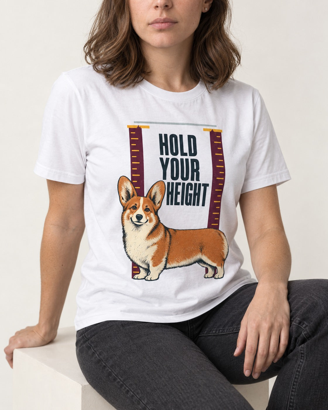 Corgi Hold Your Height T-Shirt in White, worn by a seated model