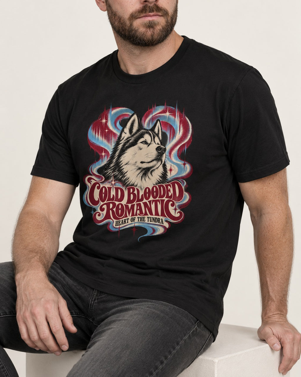 Husky Cold Blooded Romantic Heart of the Tundra Graphic T-Shirt in Black, worn by a seated model