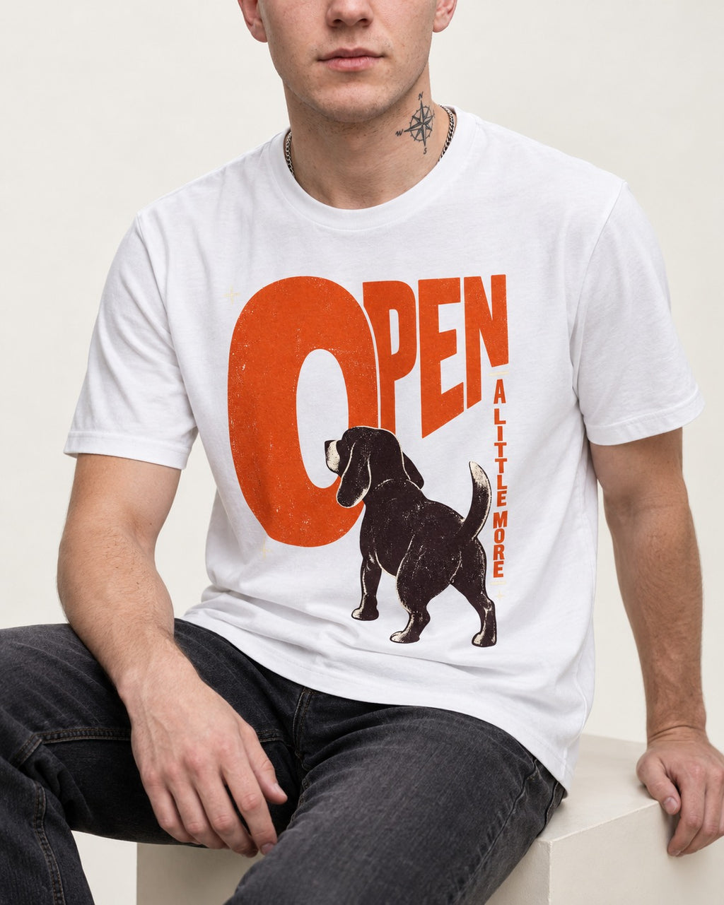 Open a Little More Beagle T-Shirt in White, worn by a seated model