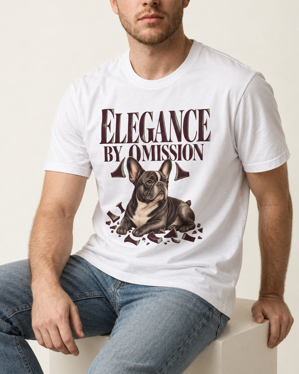 Frenchie Elegance by Omission T-Shirt in White, worn by a seated model
