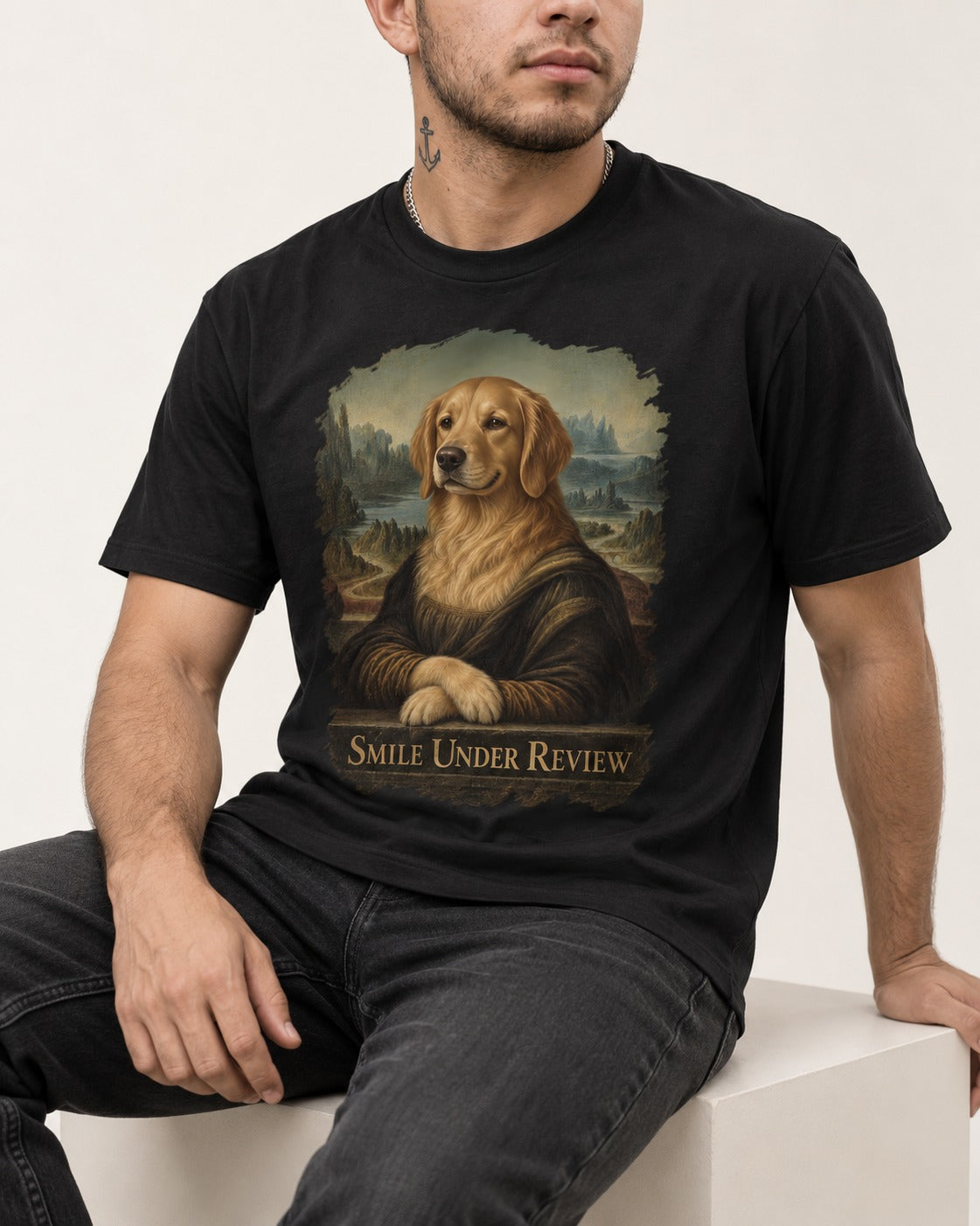 Smile Under Review Renaissance Portrait Golden Retriever Graphic T-Shirt in Black, worn by a seated model