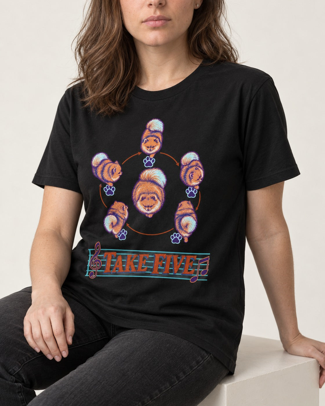 Pomeranian Take Five Choreography Cycle Graphic T-Shirt in Black, worn by a seated model